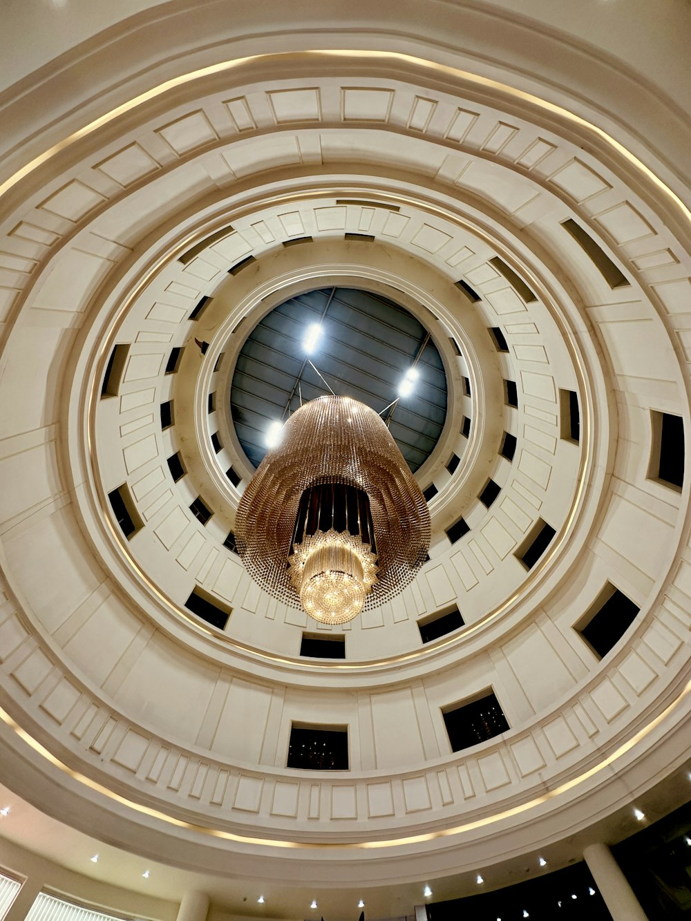 a circular ceiling with a chandelier hanging from the ceiling