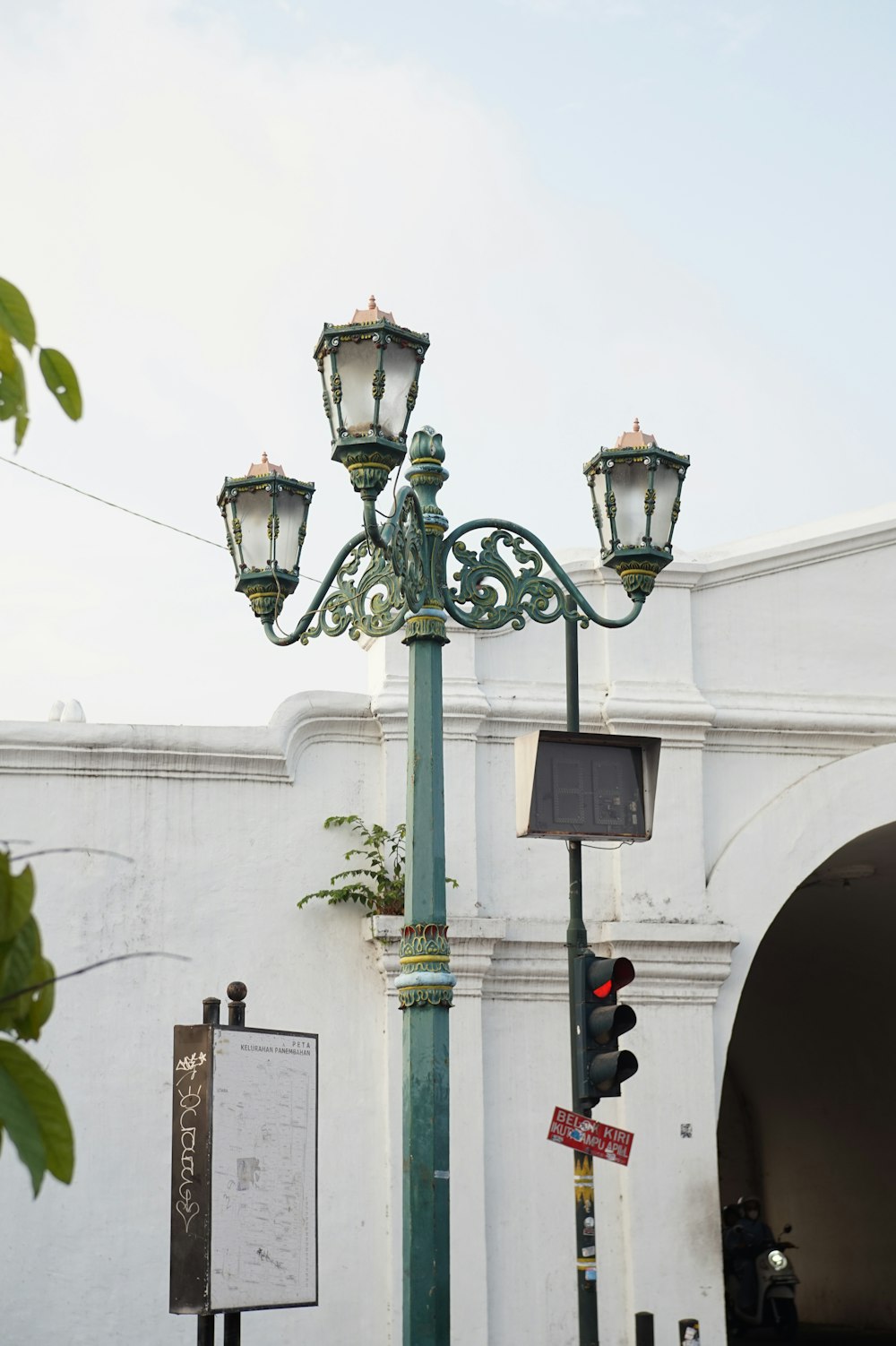 a street light sitting next to a white building
