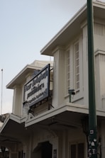 a white building with a sign on the front of it