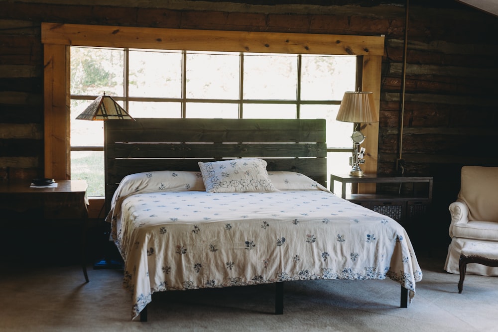 a bed sitting in a bedroom next to a window