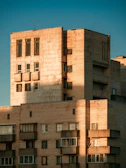 Exterior shot of Wisma Equity showcasing its raw concrete brutalist facade under soft morning light.