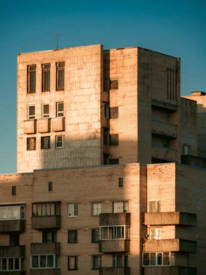 Exterior shot of Wisma Equity showcasing its raw concrete brutalist facade under soft morning light.