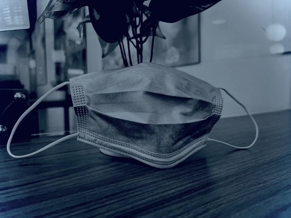 a face mask sitting on top of a wooden table