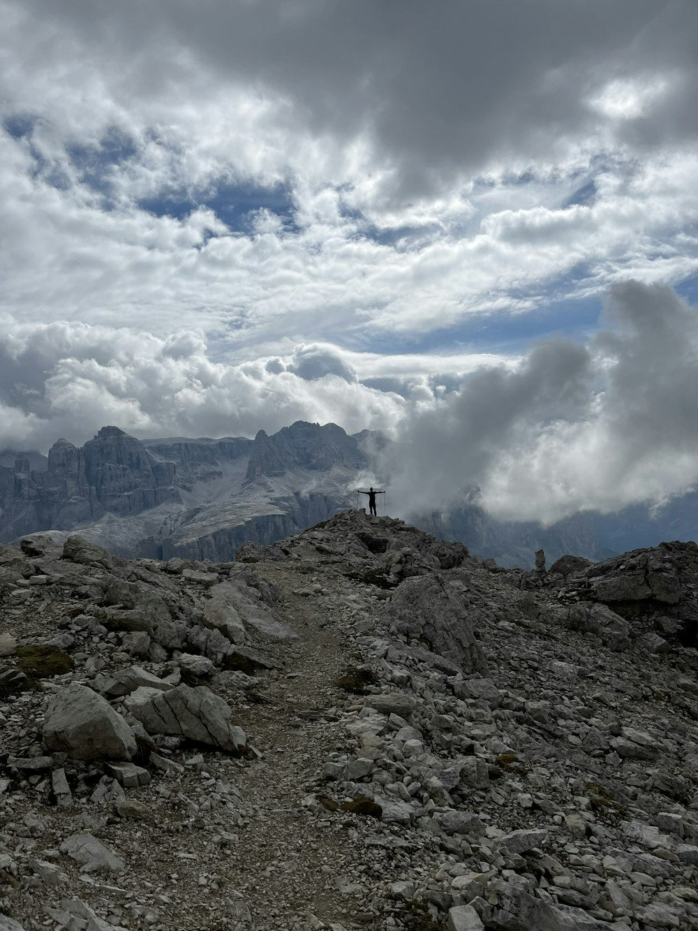 a person standing on top of a rocky hill