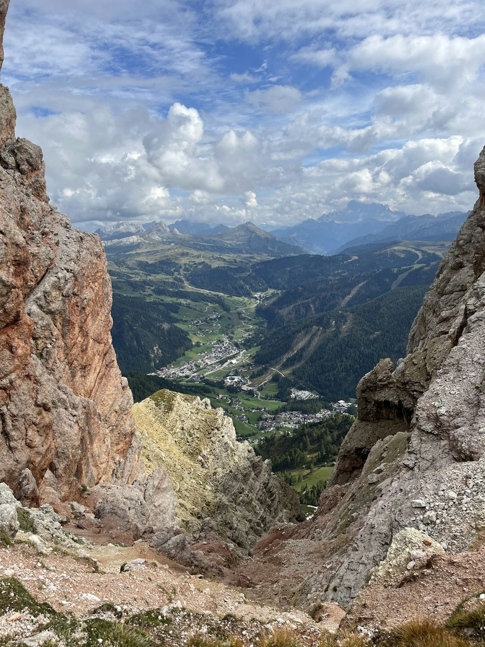 a view of a valley and mountains from the top of a mountain