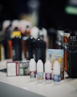 Various vape accessories like coils, batteries, and chargers neatly arranged