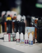 Various vape accessories like coils, batteries, and chargers neatly arranged