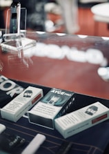A collection of vape accessories including pods, chargers, and cases arranged neatly on a bright blue background.