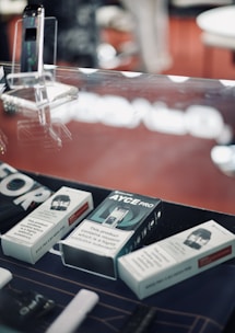 Close-up of sleek disposable e-cigarettes arranged neatly on a wooden table.