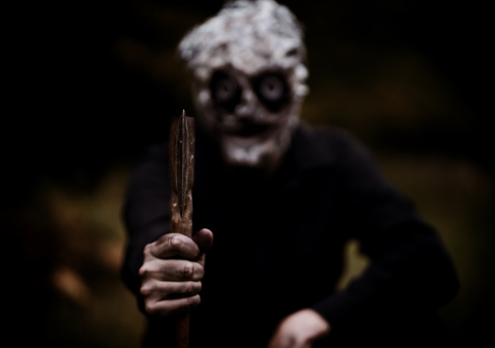 a person in a creepy mask holding a knife