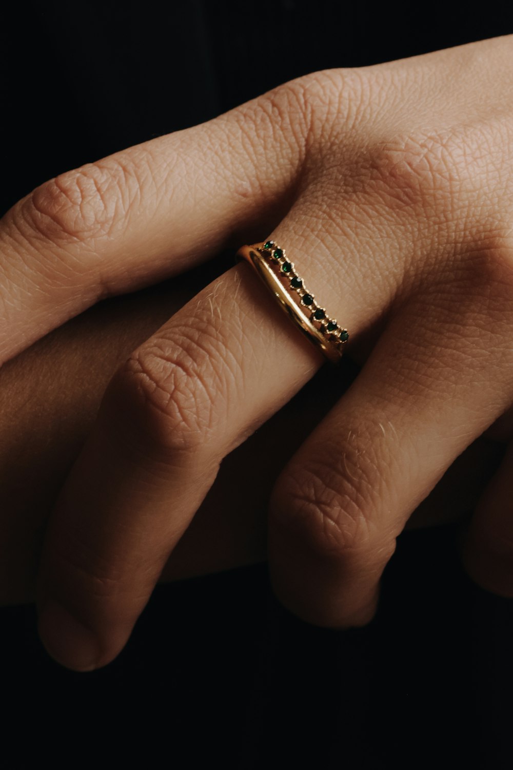 a person's hand with a ring on it