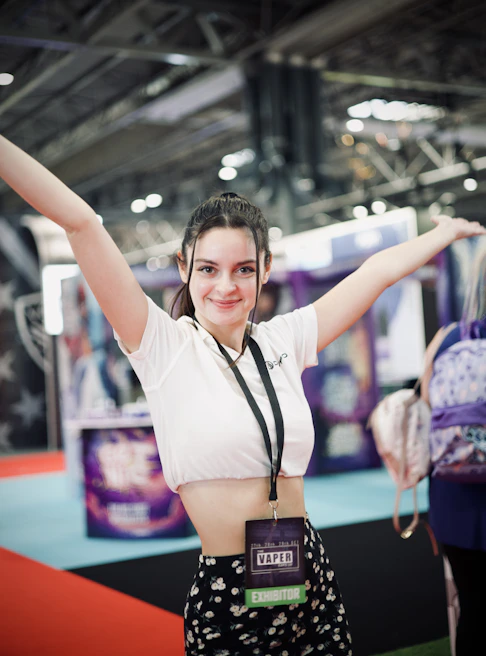 Close-up of a smiling promoter handing out branded merchandise to happy customers