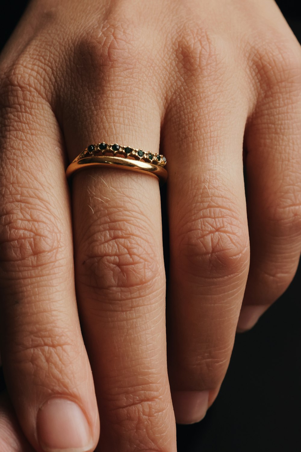 a person's hand with a ring on it