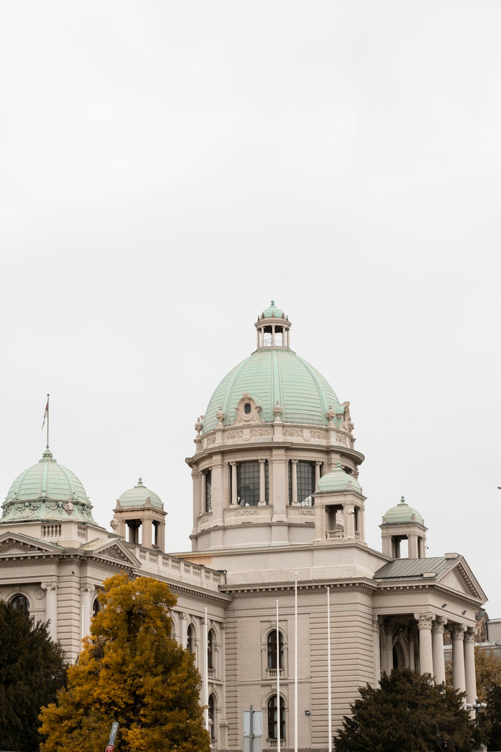 a large white building with a green dome