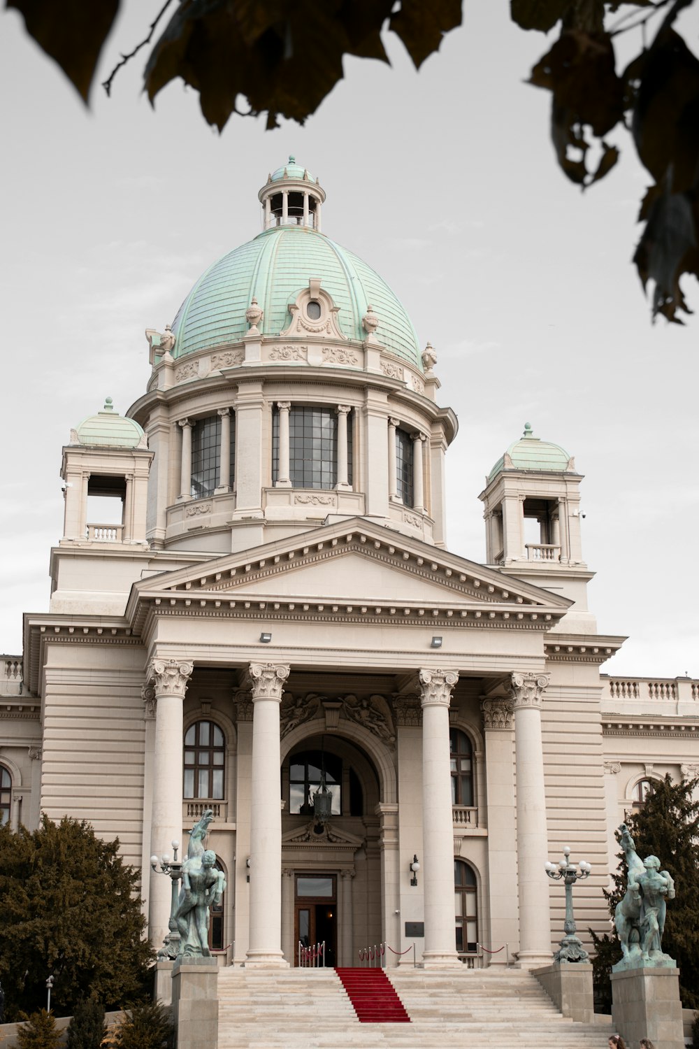 a large white building with a green dome