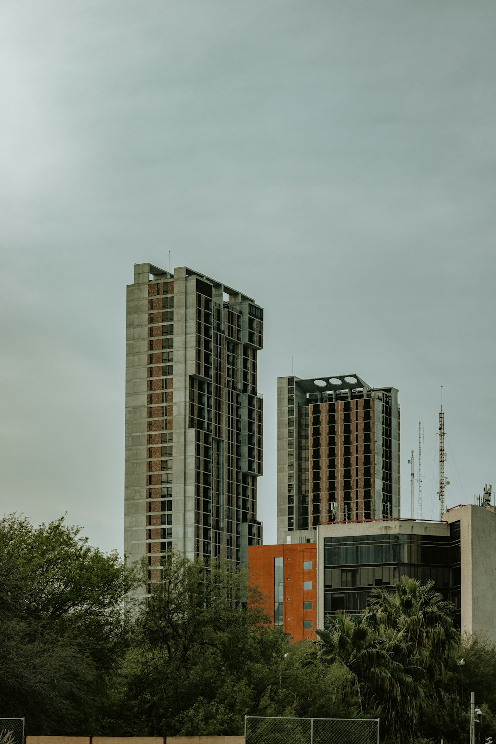 a couple of tall buildings sitting next to each other