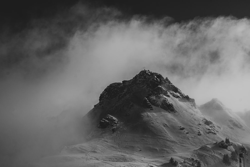 a black and white photo of a snow covered mountain