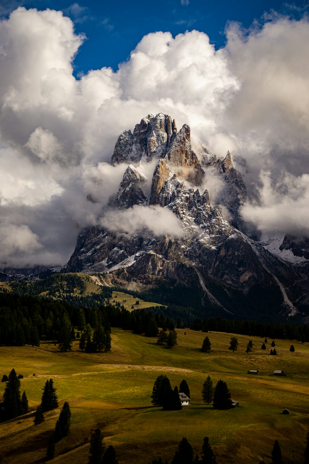 a mountain covered in clouds in the distance