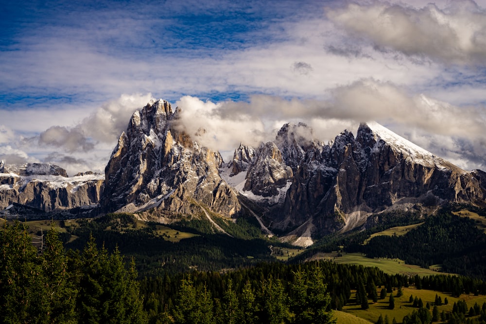 a mountain range covered in snow and clouds