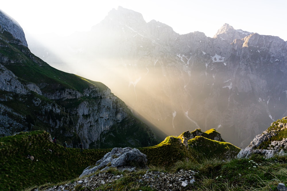 the sun shines through the clouds in the mountains