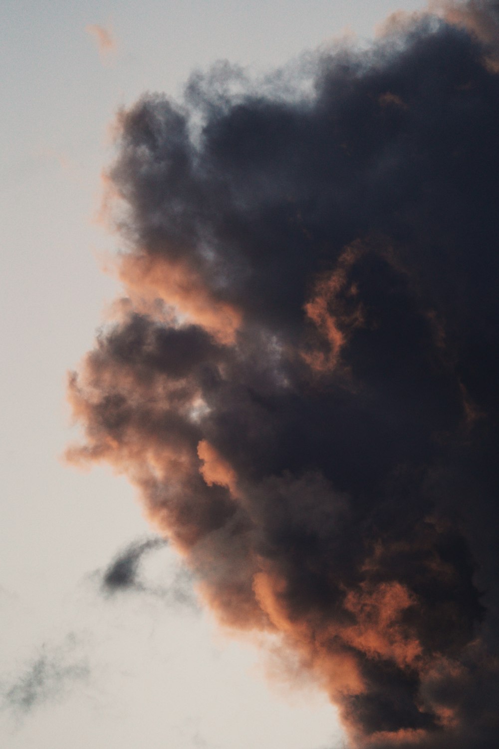 a plane flying in the sky with a lot of smoke coming out of it