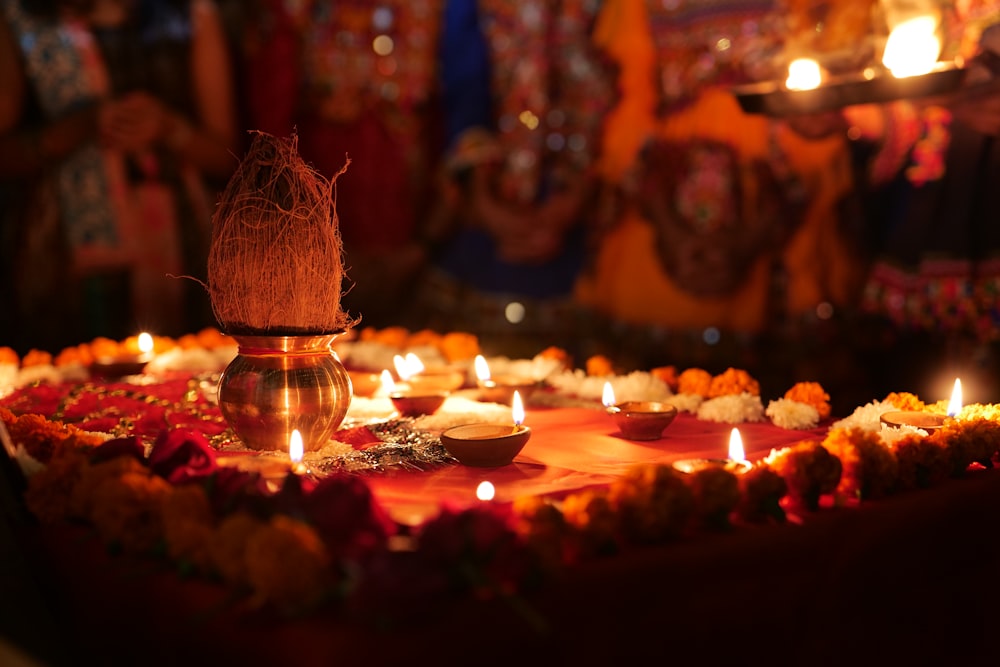 a decorated table with candles and a vase