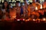 a group of people standing around a table with candles