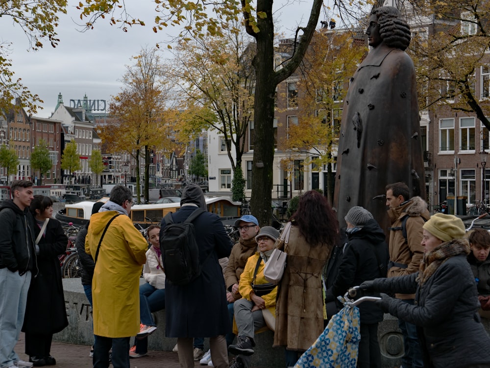 a group of people standing around a statue
