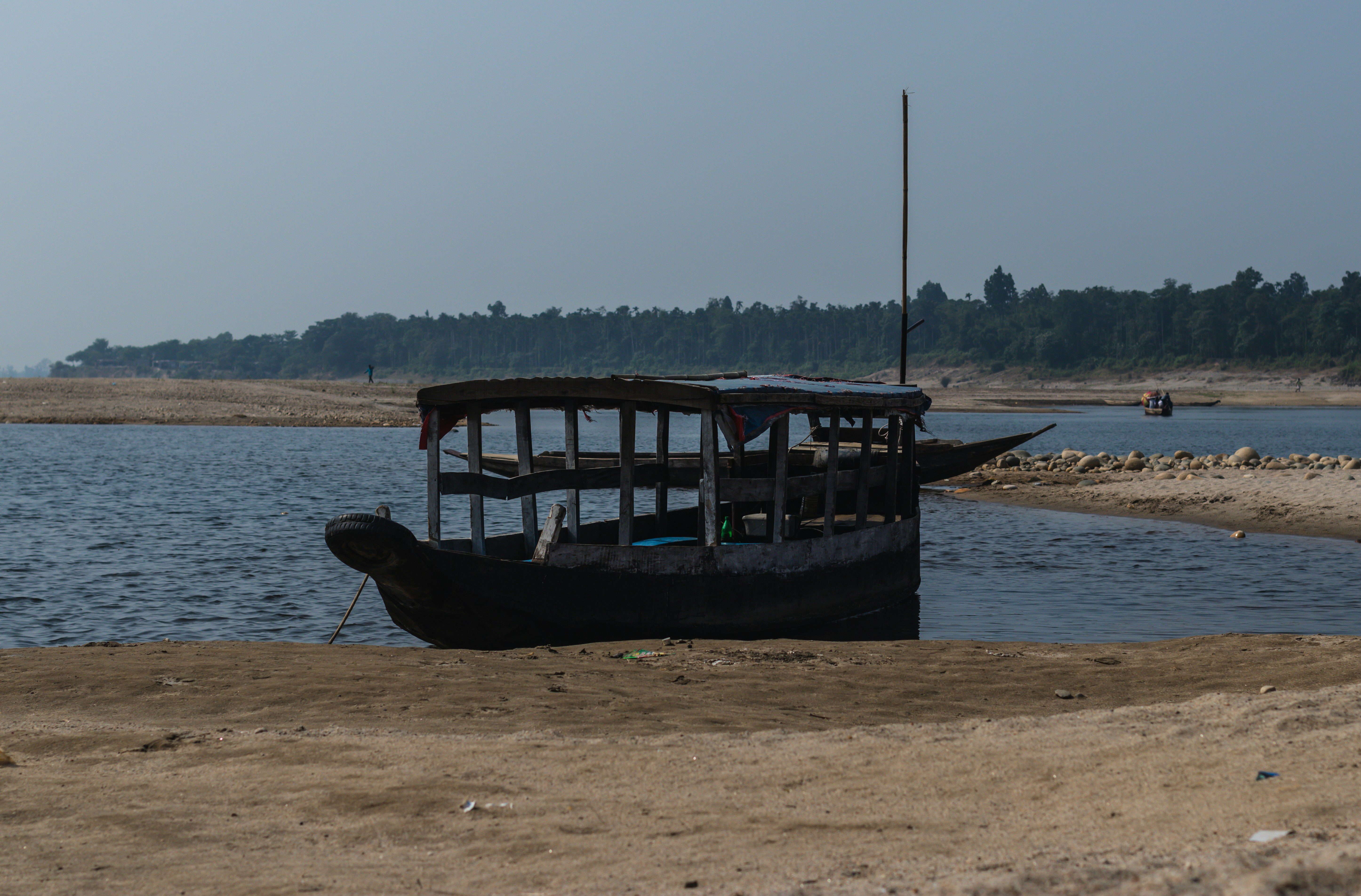 a boat sitting on top of a sandy beach