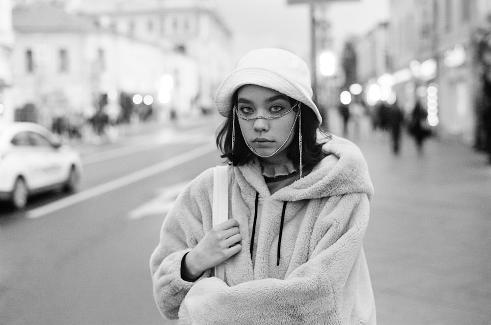 a black and white photo of a woman in a fur coat