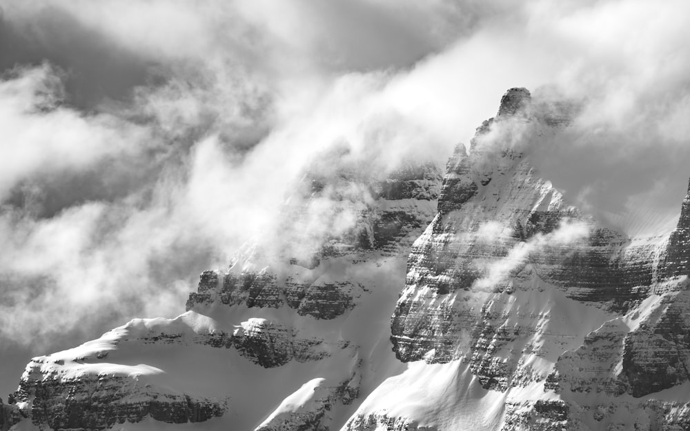 a black and white photo of snow covered mountains