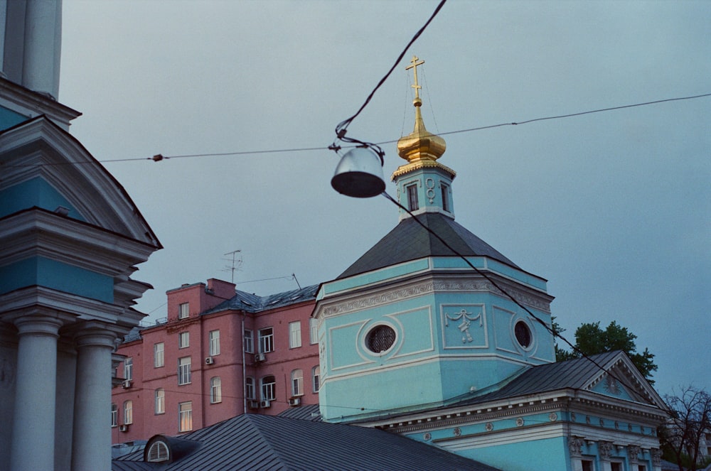 a blue and white building with a gold steeple