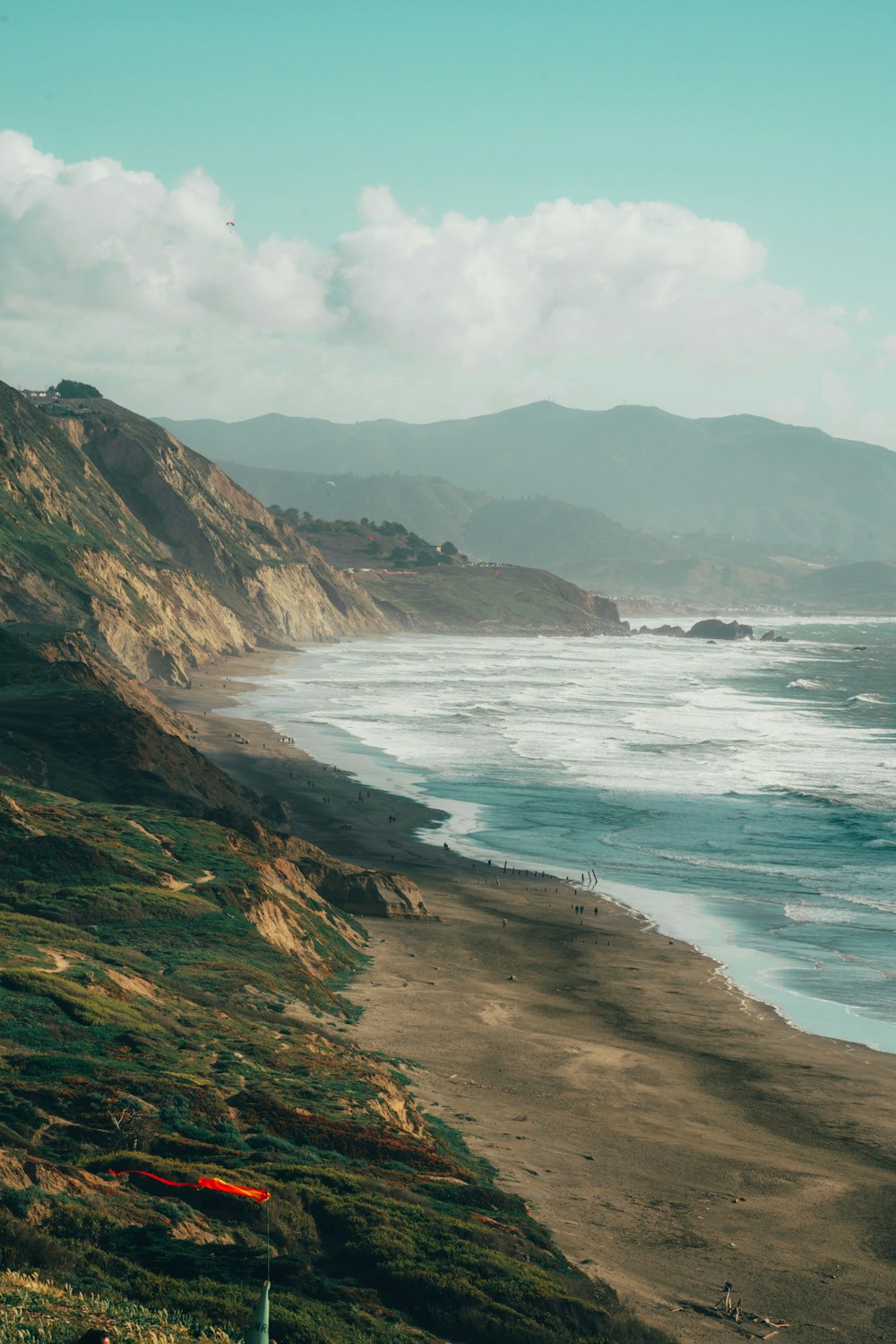 a view of a beach with a mountain in the background