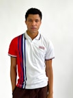 Video still showing a model demonstrating the stretch and fit of a polo shirt