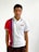 A person is wearing a sporty polo shirt featuring vertical red and blue stripes on a white background. The shirt has a design or logo with the number '1969' on the upper left side. The person's expression is calm and they are looking directly at the camera.