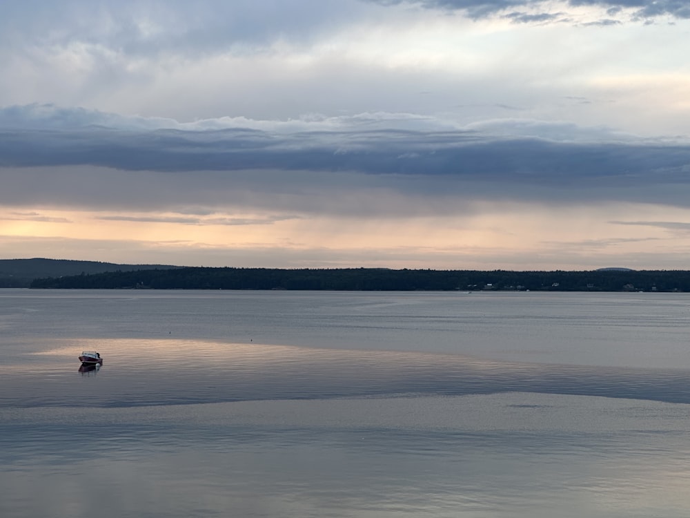 a boat floating on top of a large body of water