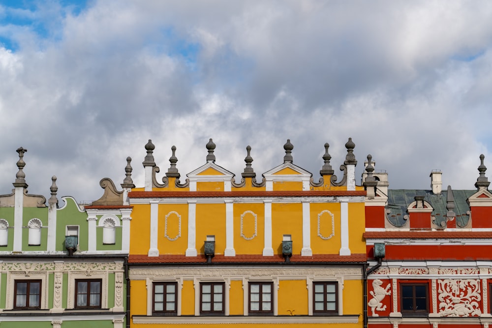 a row of multicolored buildings on a cloudy day
