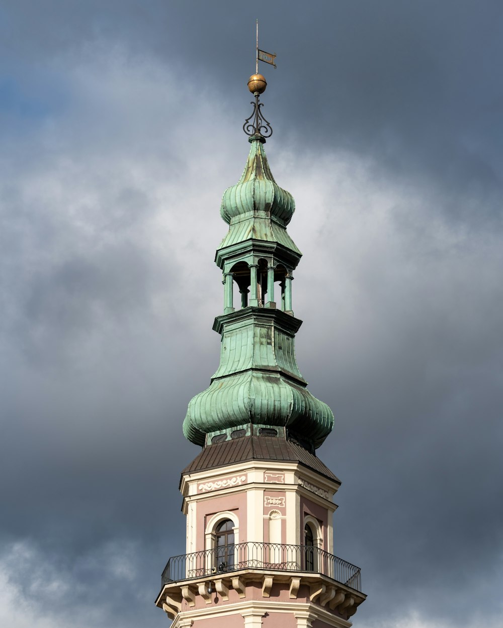 a tall tower with a cross on top of it