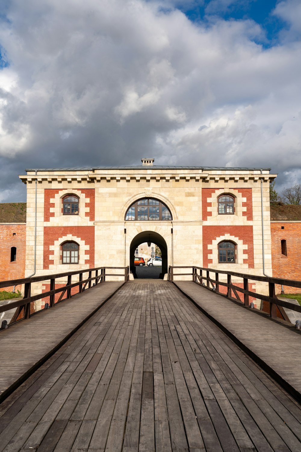 a large building with a wooden walkway leading to it