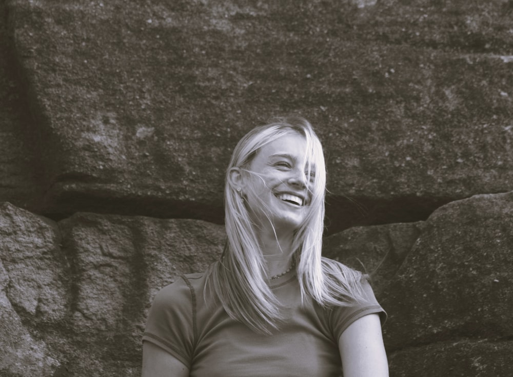 a black and white photo of a woman smiling