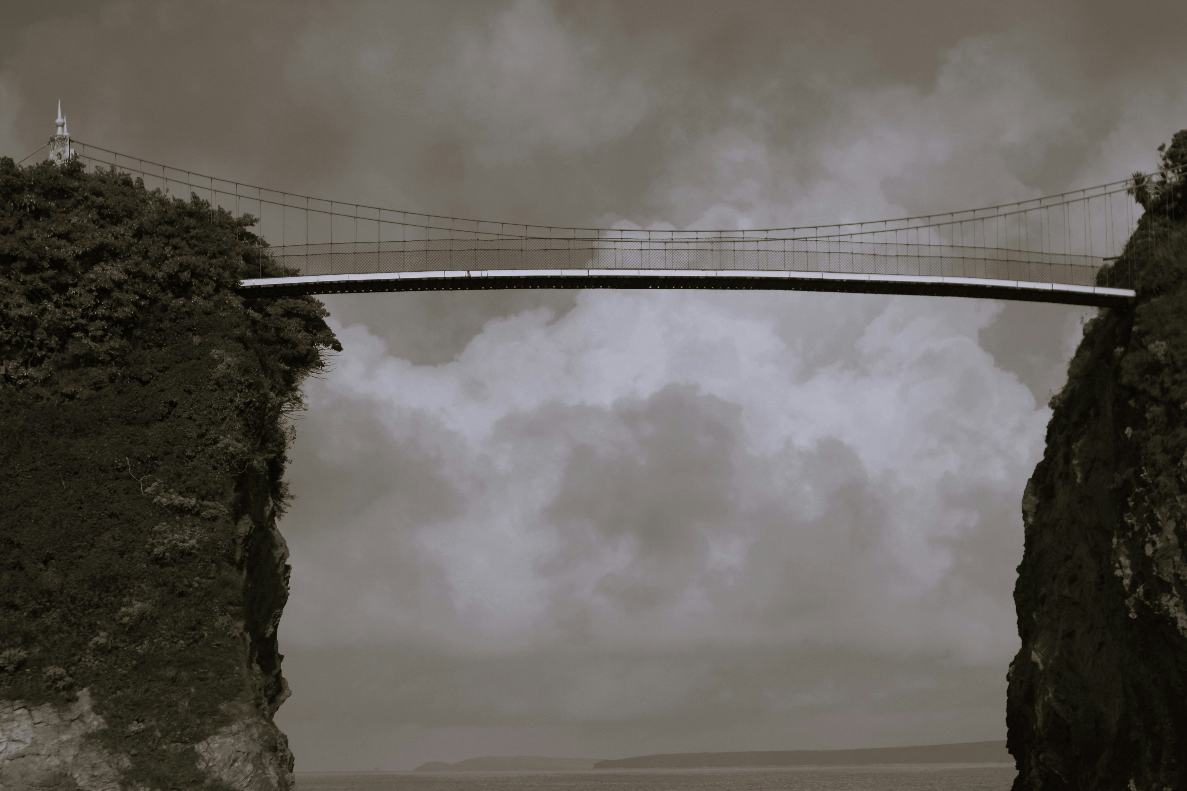 Photo of a bridge connecting two mountainous pieces of land 