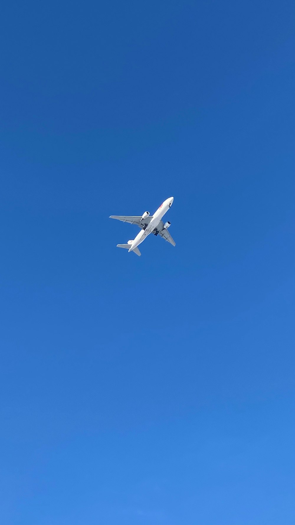 an airplane is flying in a clear blue sky