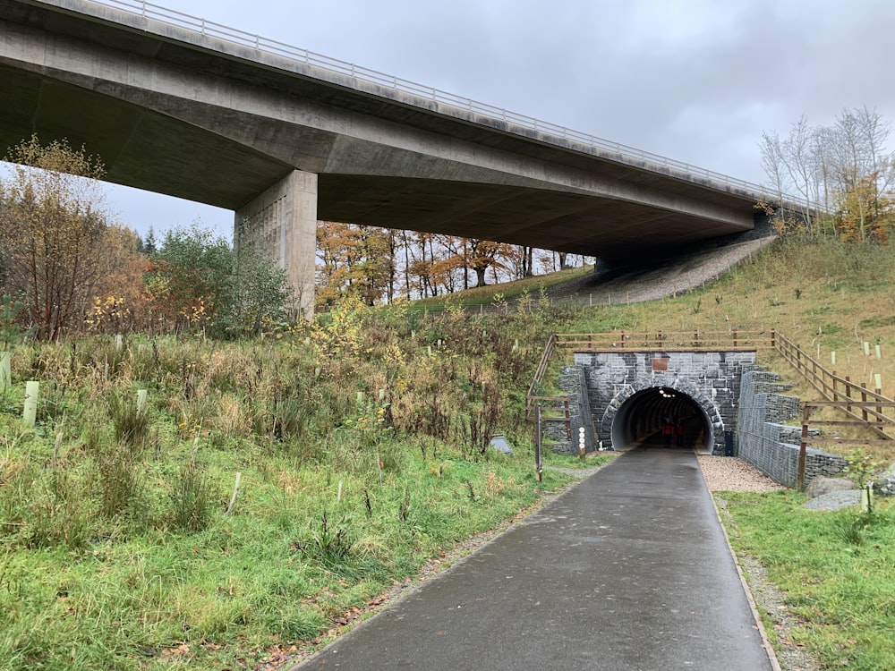 a tunnel under a bridge on a cloudy day