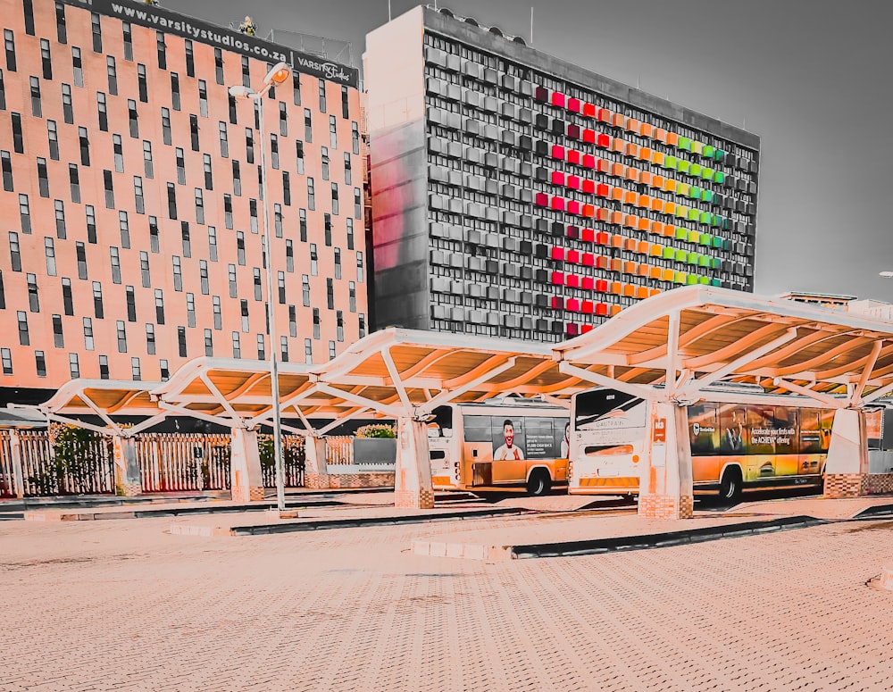 a bus stop in front of a large building