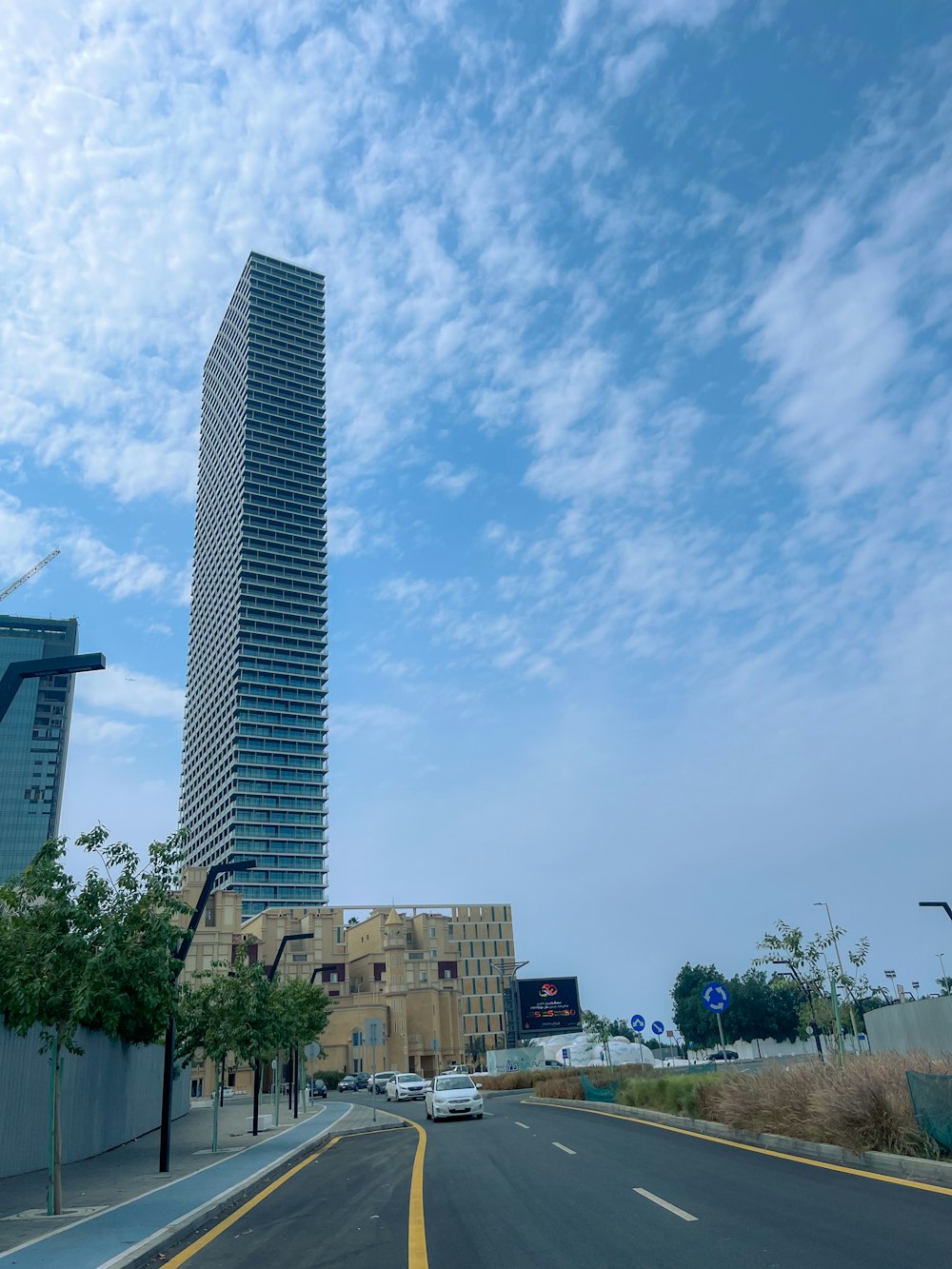 a city street with a tall building in the background