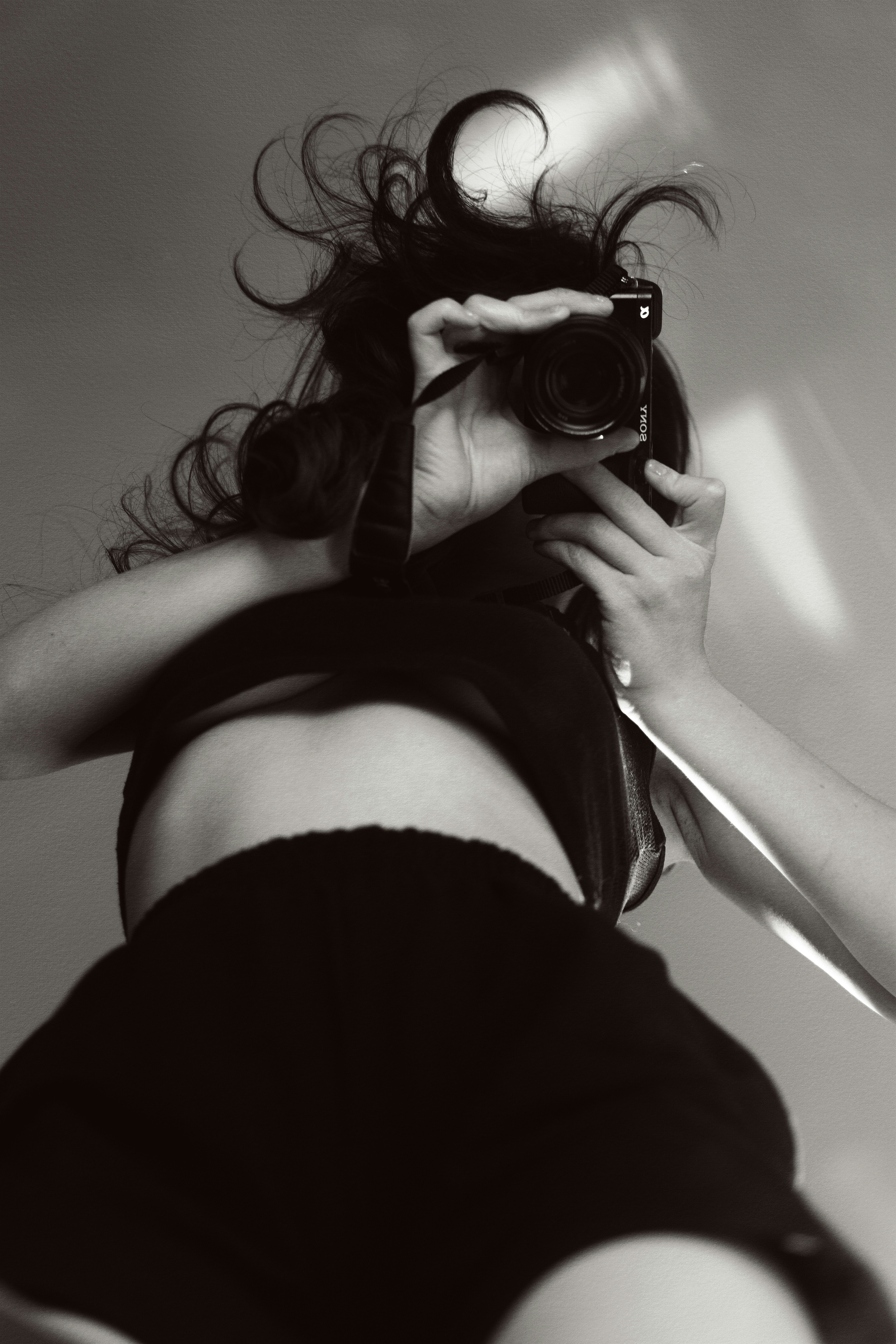 a woman taking a picture of herself with a camera