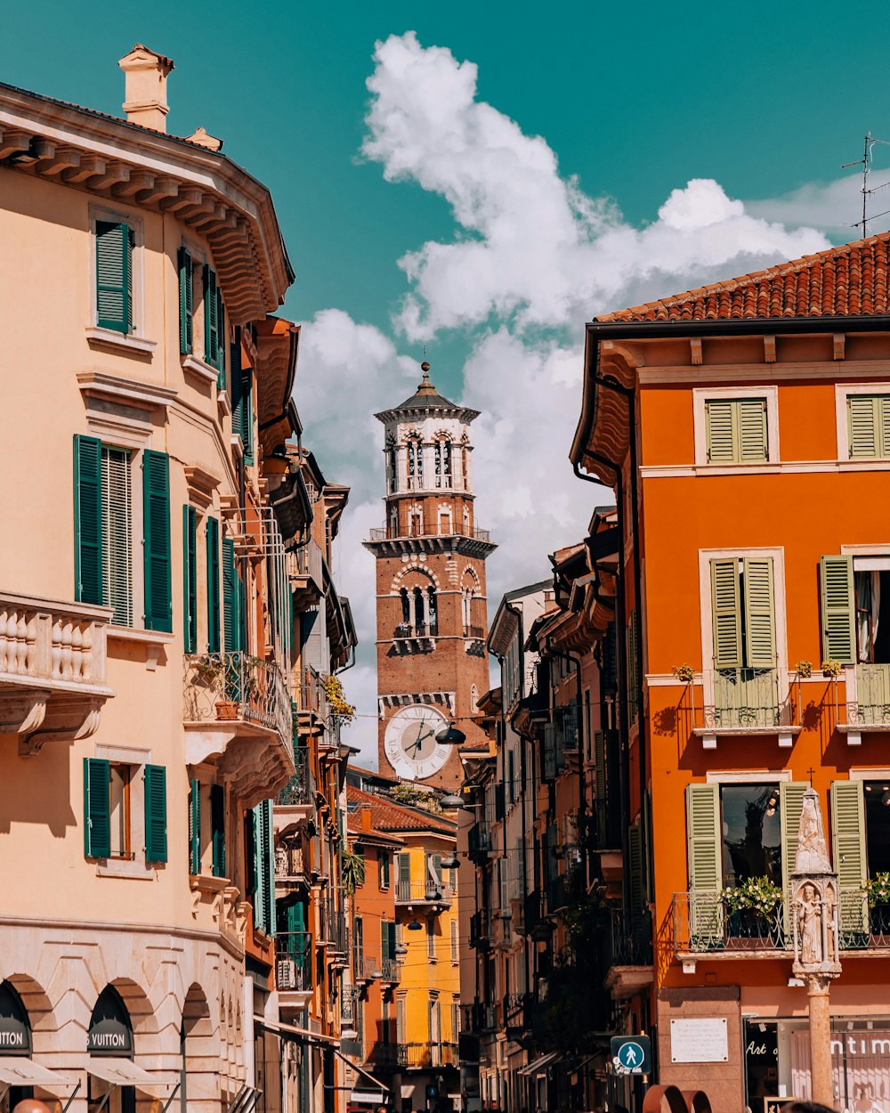 a city street with a clock tower in the background