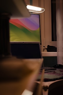 High-resolution monitor showing a vivid landscape wallpaper in a cozy workspace.