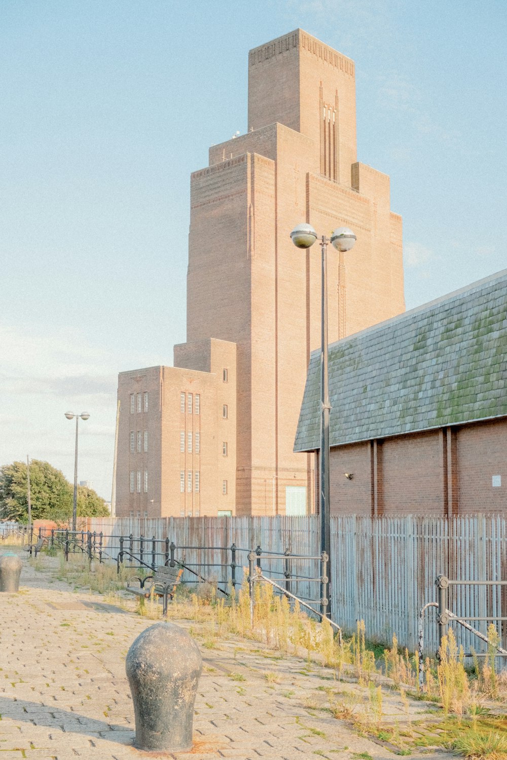 a brick building with a clock tower in the background