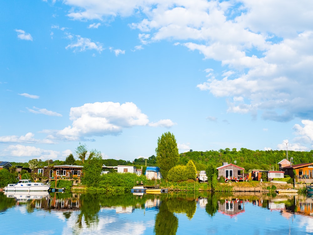 a body of water surrounded by houses and trees